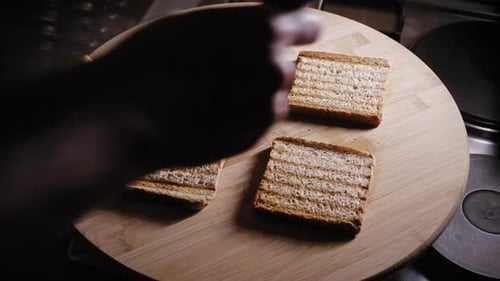 Placing Fried Eggs With Mushrooms And Avocado On Top Of Toasted Bread Slices. close up
