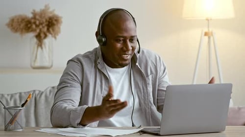 Engaged African American Man Participates in a Virtual Meeting From Home