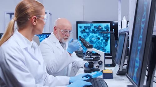 Scientists Working with Microscope in Modern Laboratory