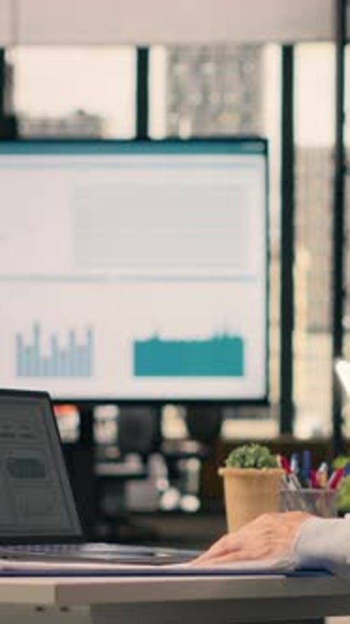 Vertical Video Man Worker Analyzing KPI Metrics and Performance Review Data in Corporate Office