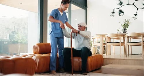 Caregiver Helping Senior Man with Cane Indoors