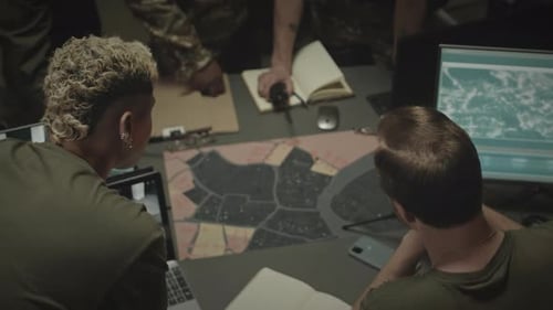 People Planning Strategy at Table with Map