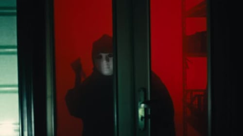 Masked Killer with Knife Behind Glass Door