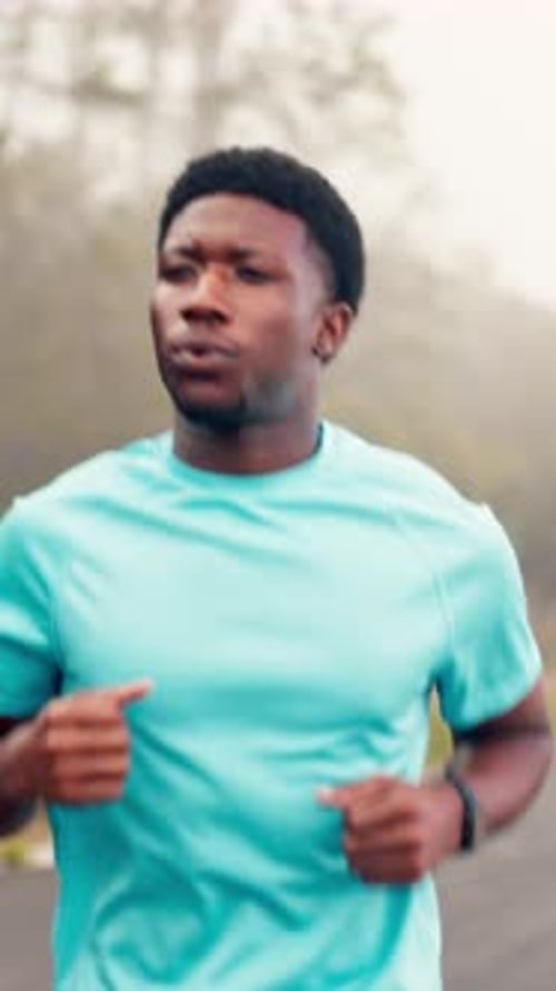 Running, athlete and man on road, outdoor and cardio for wellness in city
