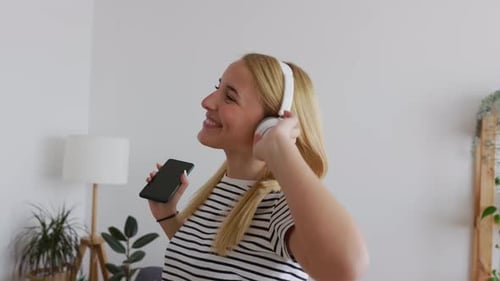 Woman Dances to Music in Her Living Room