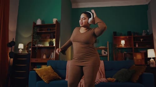Woman Dancing and Listening to Music at Home