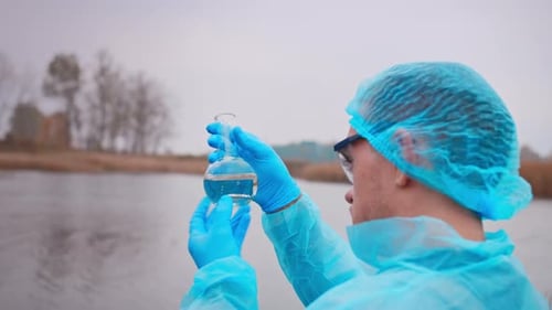 Scientist Testing Water Quality by River