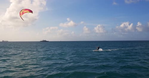 Man Kite Surfing, Wind Surfing, in Tropical Ocean Acrobatic