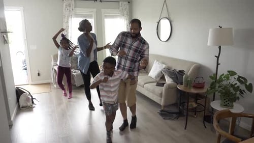 Joyful Family Dancing Together in Living Room