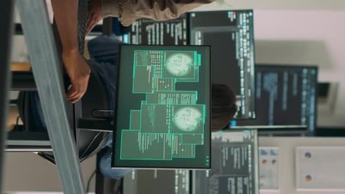 Teamwork in Tech Office with Multiple Computer Screens