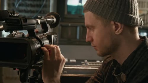 TV News Crew Operator Setting Up Camera for Recording Episode in Trailer