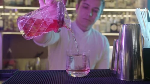 Bartender in Restaurant Pouring Drink Into Glass