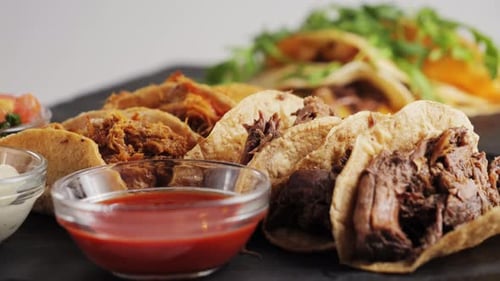 Beef Birria Tacos with Salsa and White Sauce