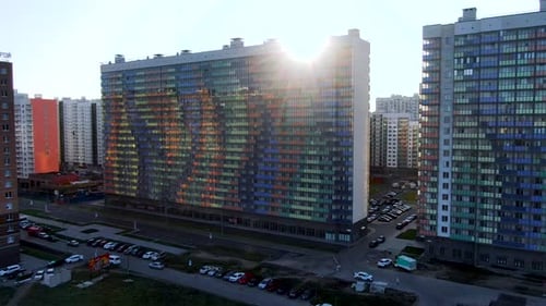 Colorful Residential Building Reflecting Sunlight at Sunset