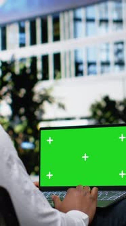 Vertical Video Green Screen Laptop with Male Typing Emails and Scrolling Through Online Content