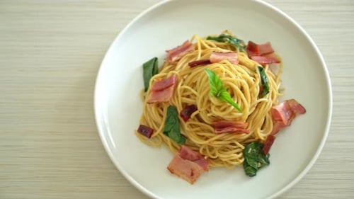Delicious Spaghetti with Bacon and Basil on Plate