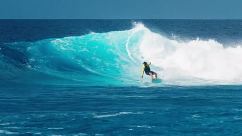 Professional Surfer Rides Big Ocean Wave in the Maldives
