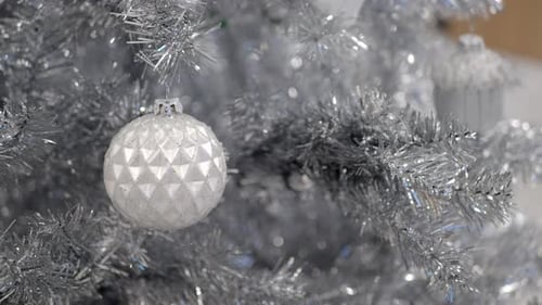 Silver Christmas Tree Decorated with Shiny White Ornament