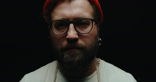 Stern Man With Beard Wearing Beanie and Glasses