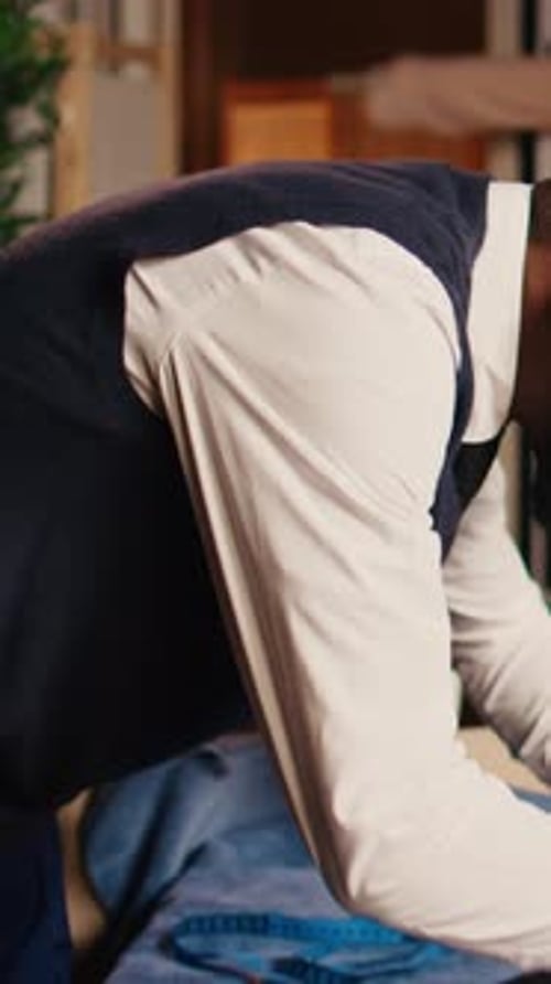 Tailor measuring fabric with ruler on table