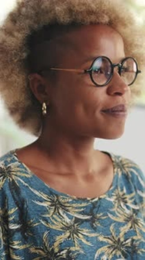 Young woman turns her head, crosses her arms and looks at the camera with smile