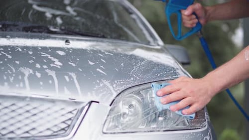 A Man and a Woman at a Selfservice Car Wash
