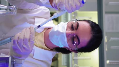 Scientist Using Pipette in Laboratory, Vertical Orientation