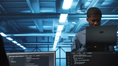 Portrait of Happy Manager Supervising Server Rows in Data Center