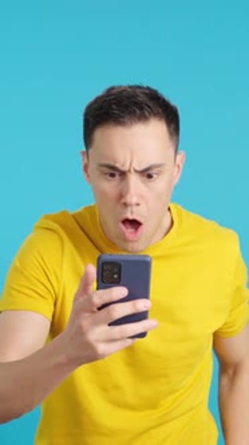 Young Adult Reacts Angrily to Mobile Phone