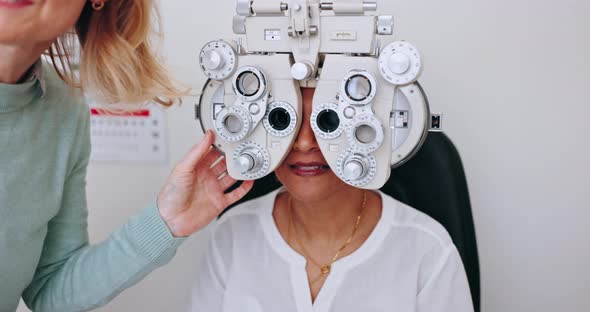 Eye exam, women and optometrist talking with patient, explain process ...