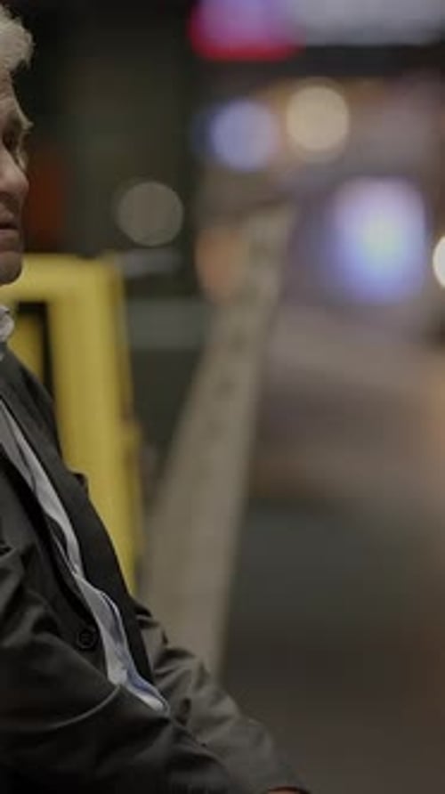 Concerned Mature Man Sitting Outside at Night