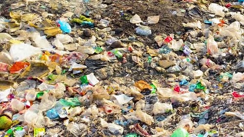 scattered plastic and polythene waste, severe environmental pollution. Detailed panning view