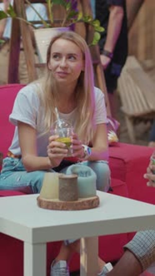 Smiling woman with blonde hair laughing with friends