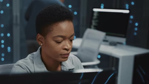 Young Woman Working on Computer in a Modern Office