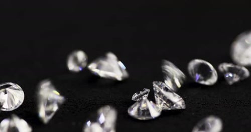 Glimmering Diamonds Falling on Black Surface