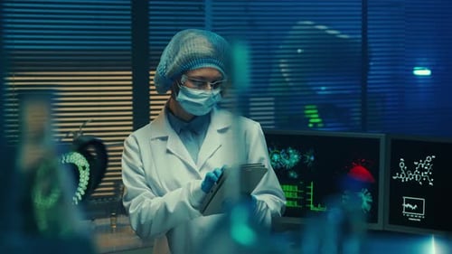 Woman Doctor Examines Glass Vials Flasks Test Tubes and Enters Data Into Tablet