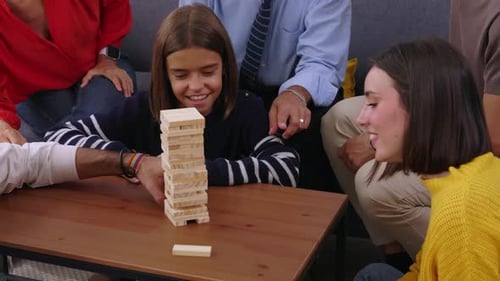 Happy Group of Multigenerational Family Having Fun Playing Block Game at Home