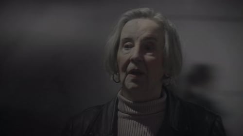 Person with Gray Hair Wearing Leather Jacket at Night