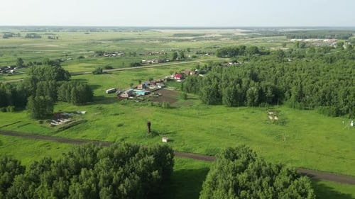 Lush Rural Landscape Revealing Verdant Green Fields Woodland Patches Scattered Residential Buildings