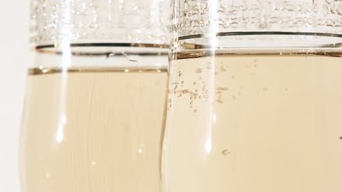 Sparkling Wine in Two Champagne Glasses Close Up