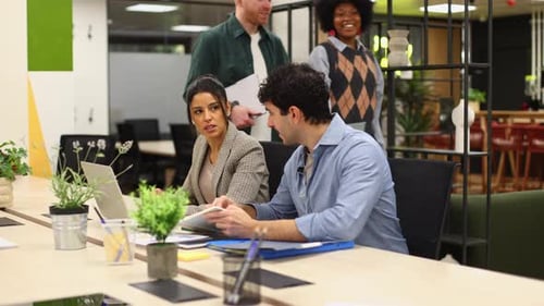 Diverse Team Collaborating on Project in Modern Office