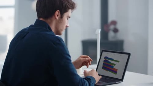 Close Up Focused Businessman Working on Laptop Computer in Home Office. Portrait
