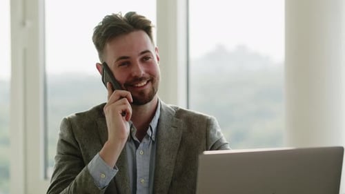 Young Man Businessman Working in an Office Happy Man Speaking with Phone to Someone He End Talking