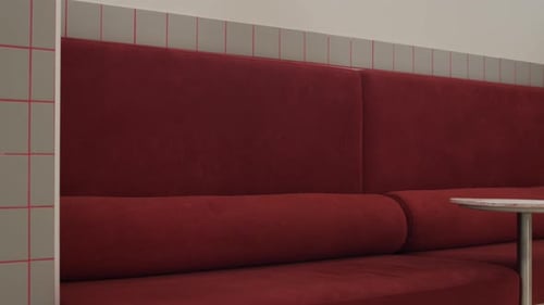 Cozy Seating Area in Modern Coworking Space with Red Velvet Sofa and Table