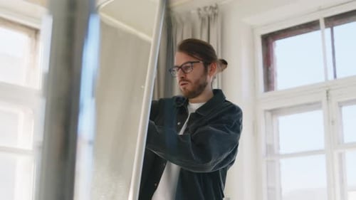 Professional Photographer Working in Sunlit Studio