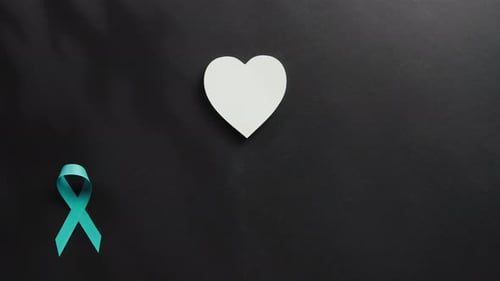 Ribbons Symbol of Cancer Awareness Day on Black Flat Lay Background