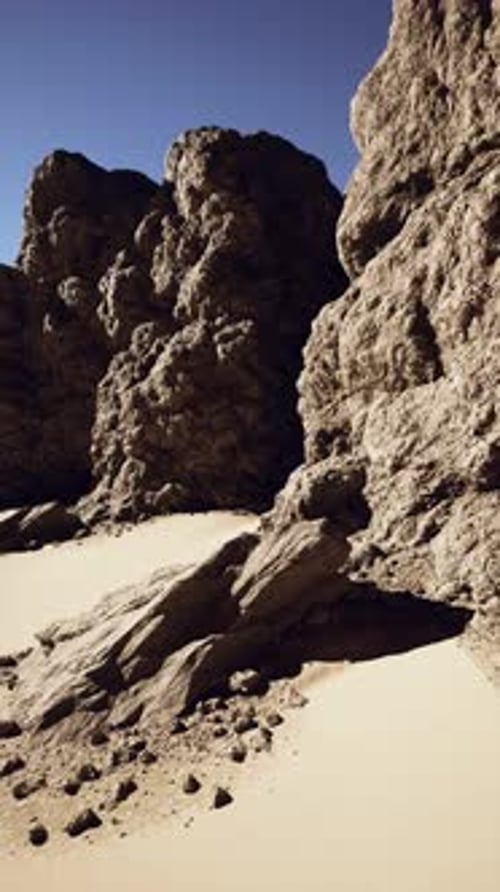 Sunlit Rocks and Sand in Desert Landscape
