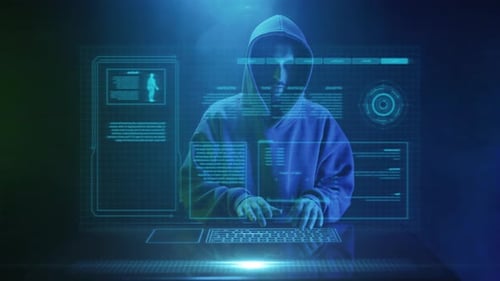 Hooded Hacker Typing in Futuristic Digital Environment