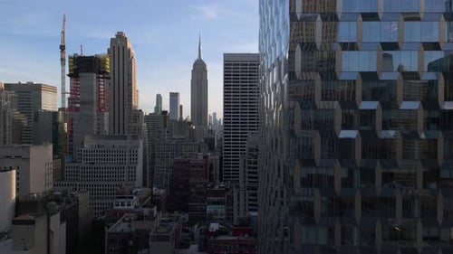 Aerial view flying in middle of buildings in Manhattan, sunny day in New York