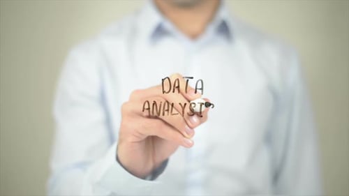 Man Writes Data Analysis on Transparent Surface